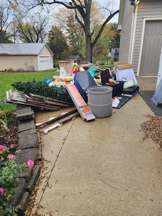 Dumpster being loaded with debris for 12 Yard Dumpster Rental in Kingsland